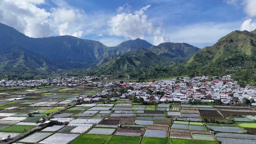 Aerial View of Rural Village and Agricultural Fields in Mountain Valley