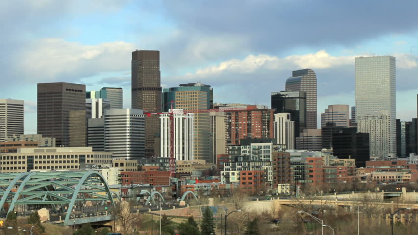 Busy afternoon traffic and skyline in downtown Denver, Colorado.  All logos