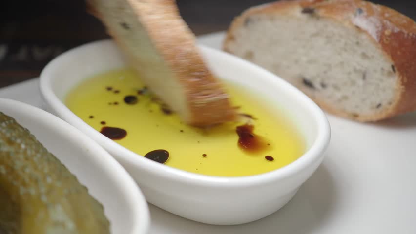 Enjoying bread with olive oil and balsamic vinegar dip
