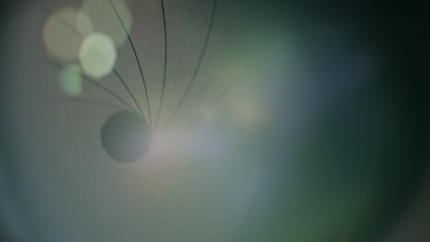 Camera lens with lens reflections and movement of the internal shutter , close-up