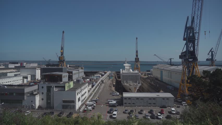 Port de Brest. Sunny day in Brest, France vibrant port city. Scenic views of Atlantic coast, industrial cranes, cargo ships and bustling docks blend, reflecting rich maritime heritage and commerce. 