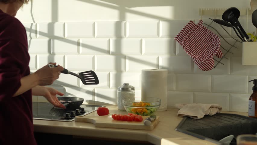 Cooking in a bright kitchen as someone prepares fresh vegetables for a meal on a sunny afternoon