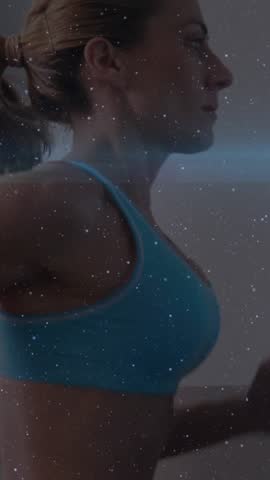 Animation of Caucasian woman running on treadmill in gym with glowing blue light moving in the foreground. Exercise achievement concept digital composite.