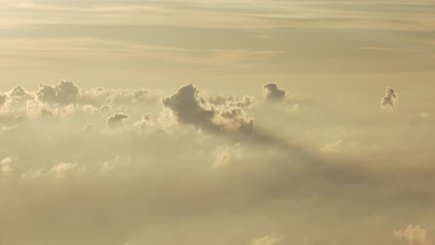 Vast clouds with long shadows in the golden hour sky.