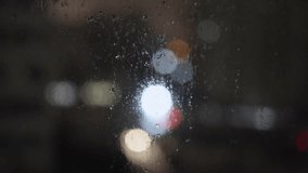 Slow motion of car headlights reflecting on wet asphalt during night rain in a city. Abstract cinematic traffic bokeh, moody urban atmosphere, and rainy street scene. Copy space included.  - Powered by Shutterstock - Get 15% off with code: PIKWIZARD15