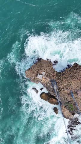 Aerial View of Ocean Waves Crashing on Rocky Coast in Indonesia