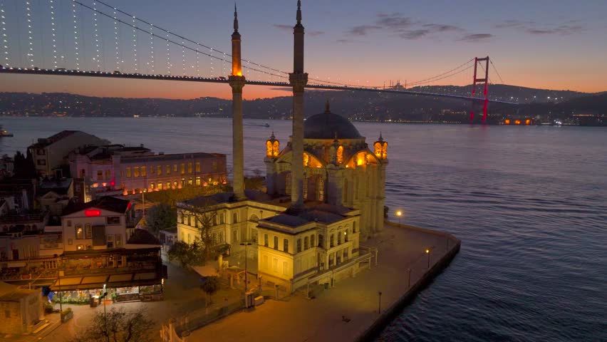 Aerial drone view of Istanbul. Ortakoy Mosque located on the shore of the Bosphorus and the Bosphorus Bridge at sunrise. Symbol of tourism in Turkey, the best tourist destination. Night.