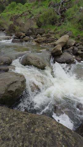 Rushing creek rapids over rocks in Yolo County