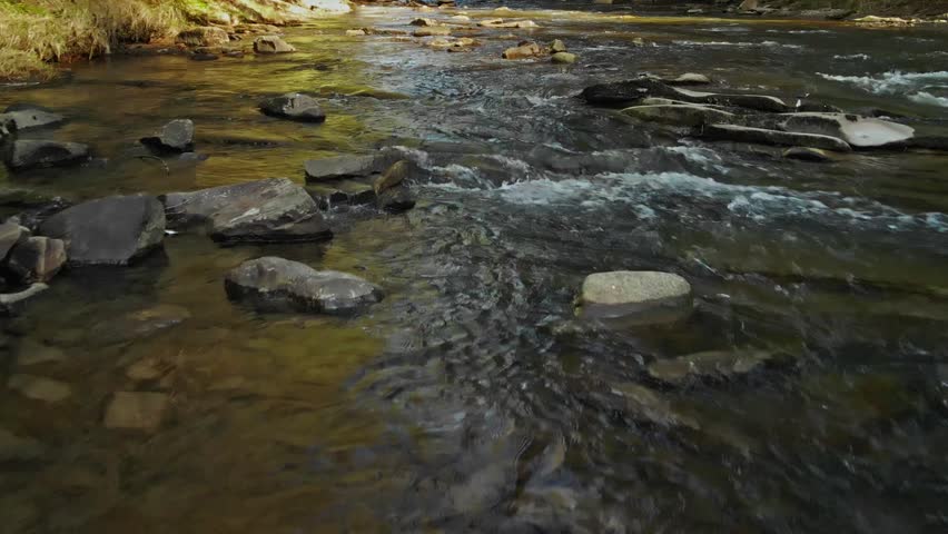 Rapid Water Over Rocky Riverbed Details. Brisk Water Rushing Through Textured Bed In Czech Landscapes