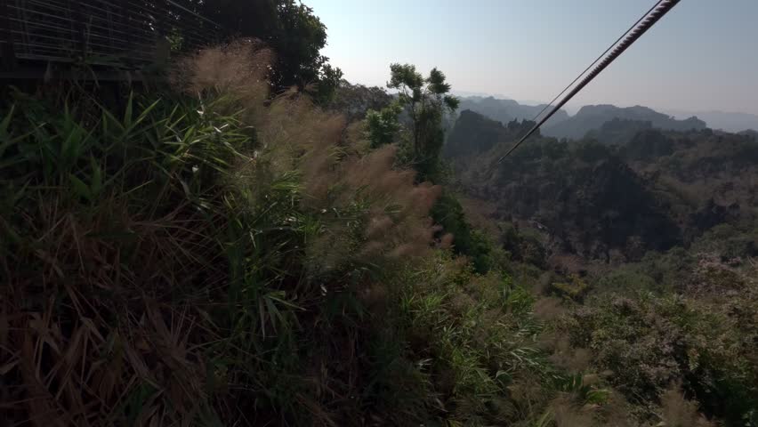 A POV shot of a large zipline at The Rock viewpoint, Laos.