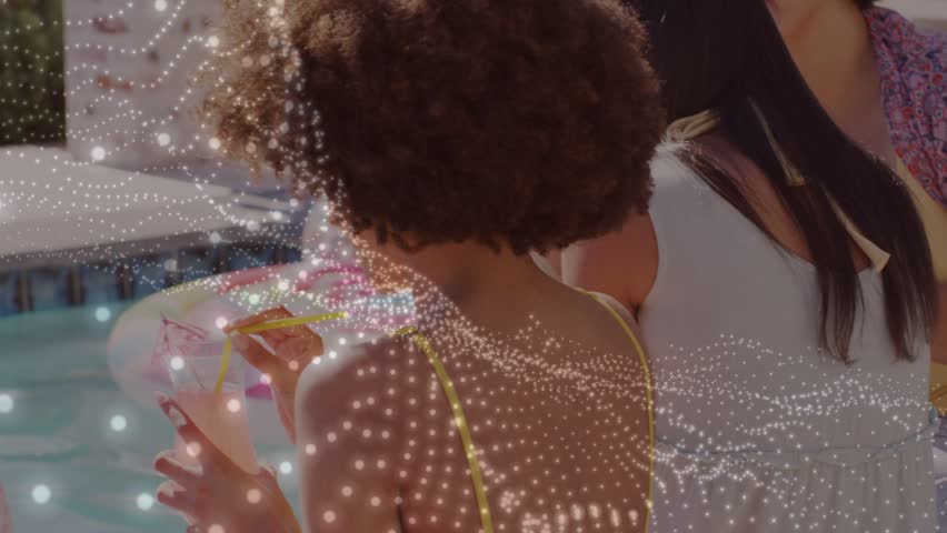 Woman inspecting yellow item, showing friends poolside social, animated dots sweeping across group. Pool, backyard, sunshine, curly, laughter, hat, beverage