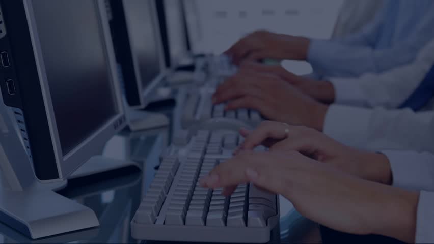 Team typing initiating floating social icons over screens and showing live business alerts. Keyboard, monitors, headset, workstation, coworkers, collaboration, networking