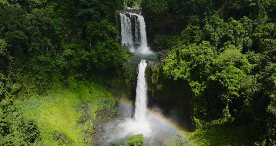 Beautiful waterfall among the rainforest and vegetation. Limunsudan Falls. Mindanao, Philippines.