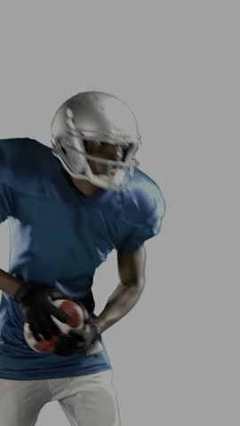 Vertical video: Player catching and securing ball shifting to move as sports HUD animating beside. Football, athlete, studio, overlay, graphics, motion, vertical video