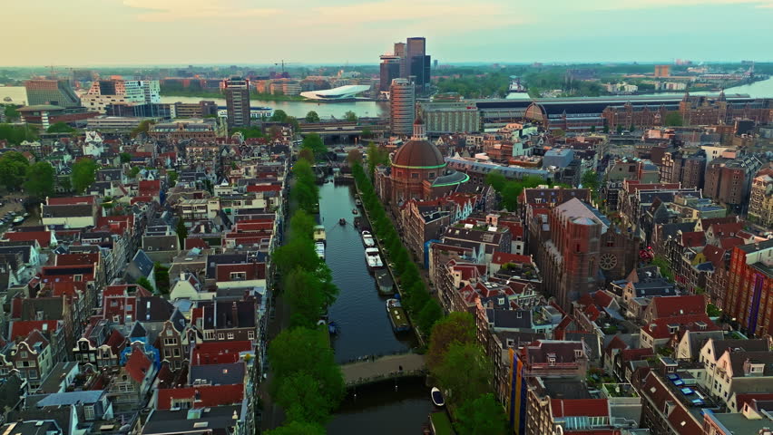Aerial view of Amsterdamat at sunset with canals, boats. Historic Dutch city of Amsterdam, capital of the Netherlands