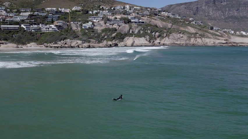Slow Motion Aerial Drone Shot of Surfer at Llandudno Beach, Surfing Cold Atlantic Waters in Cape Town South Africa