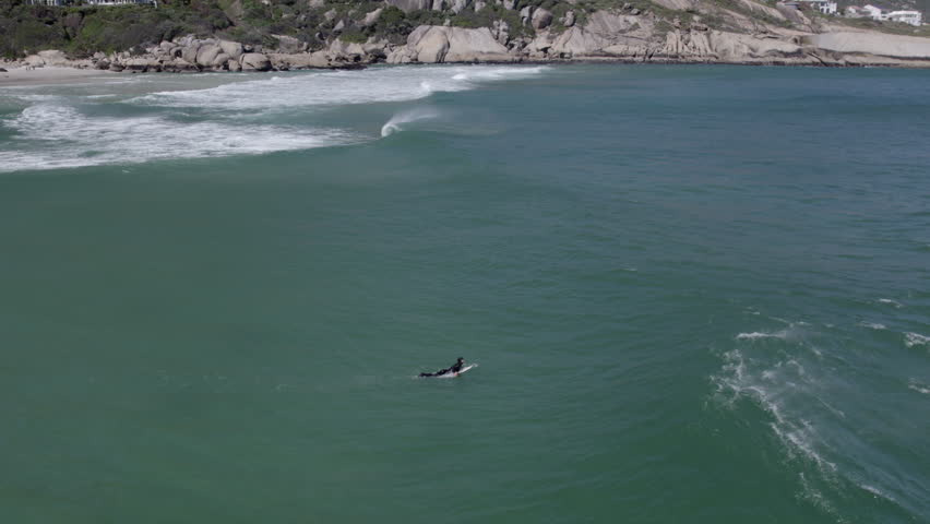Slow Motion Aerial Drone Shot of Surfer at Llandudno Beach, Surfing Cold Atlantic Waters in Cape Town South Africa