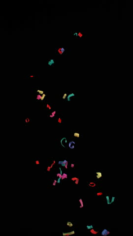 Super slow motion of flying confetti isolated on black background. Filmed on high speed cinema camera