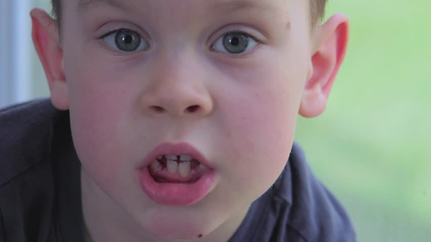 A heartfelt, intimate closeup of a young boy showcasing his genuine emotions with his bright, clear blue eyes