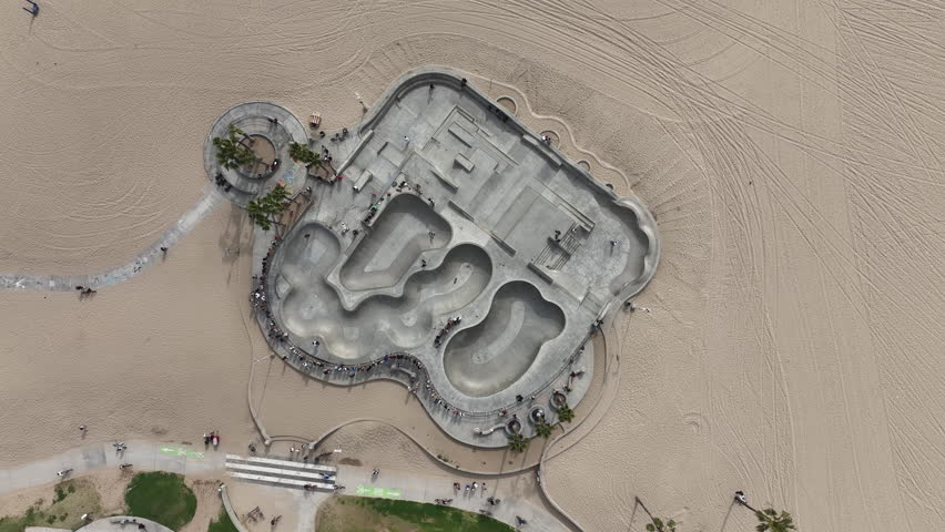 Venice Beach, California, USA - Drone View of Skate Park at Boardwalk From Above With Skaters Skating and Tourists Looking