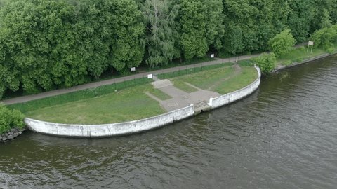 Drone Orbiting Curved River Embankment Park