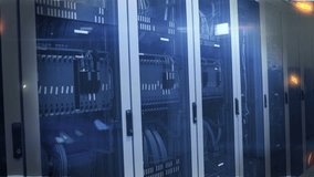 Server racks lining server room, camera panning causing glowing labels showing network traffic. Datacenter, cabinet, cabling, fiber, patchpanel, module, led - Powered by Shutterstock - Get 15% off with code: PIKWIZARD15