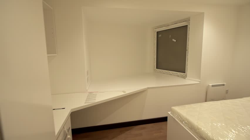 Modern studio room with kitchen, wardrobe, desk and bed in compact layout