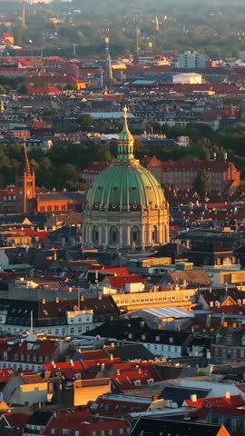 Aerial drone footage of Copenhagen skyline with Marble Church during golden hour.