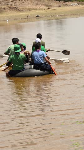 Scouts on the lake, riding on a raft.