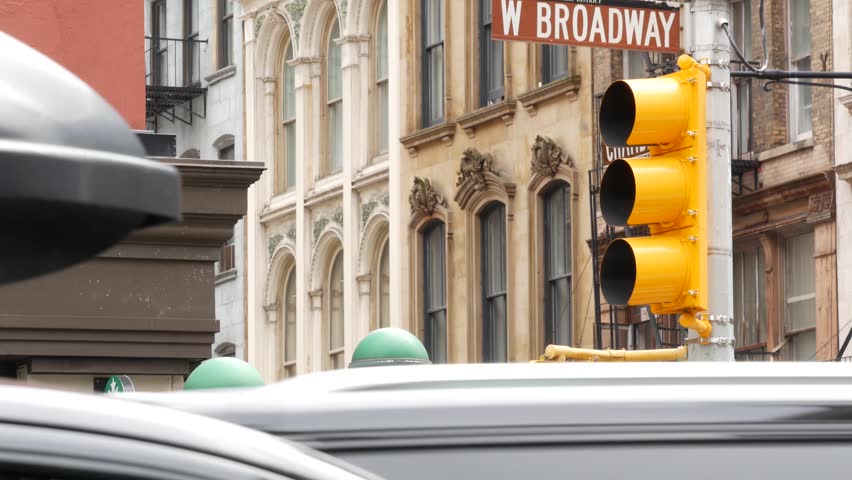 New York West Broadway street sign in Lower Manhattan, United States. Urban road sign in american city, traffic sign in NYC. Architecture of Tribeca district. Subway entrance green globe, orb lamp.