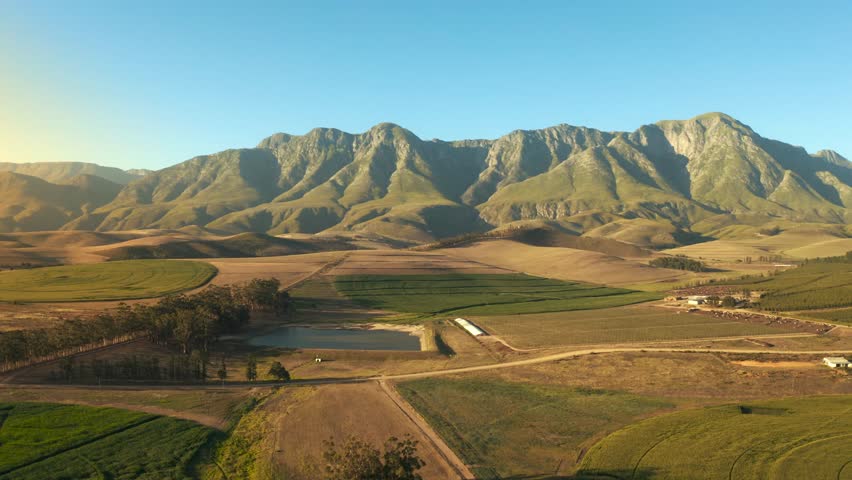 An Aerial Footage of Agricultural Lands and Mountains