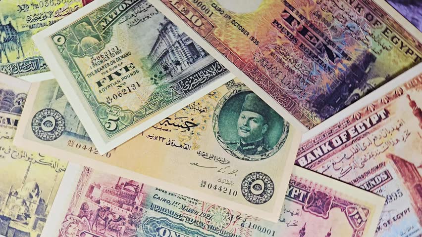 closeup of a collection of rare, vintage Egyptian banknotes, from the late 19th and early 20th centuries, old vintage retro Egyptian cash money banknotes at the era of the kingdom of Egypt and Sudan