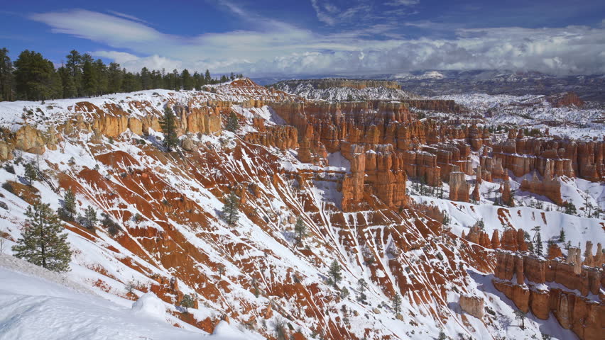 Panning shot of Bryce Canyon national park with snow falling in winter season, Utah, USA