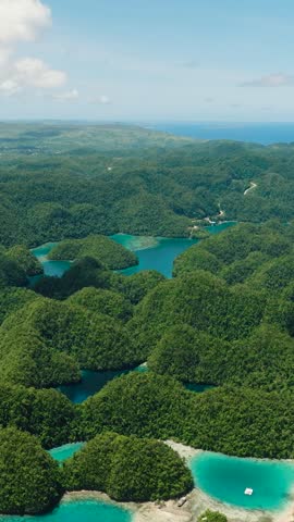 Mountain hills and lagoons in Bucas Grande. Transparent turquoise sea water, natural composition. Sohoton cove. Mindanao, Philippines. Vertical view.