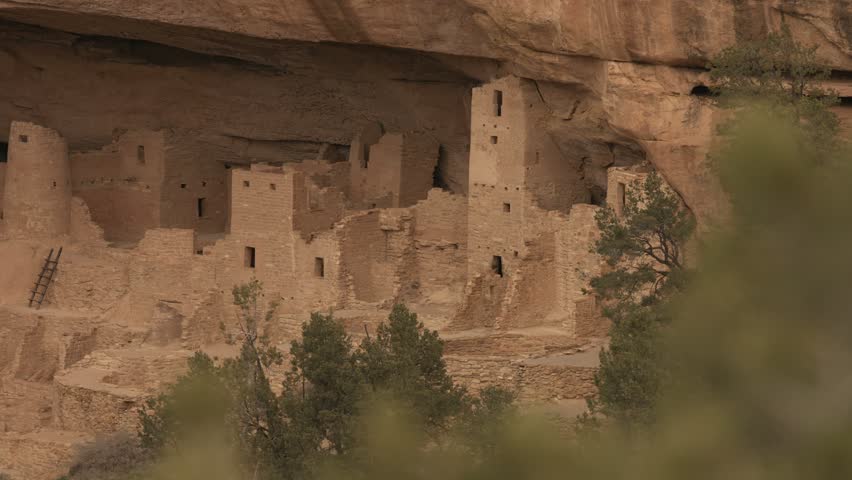 This 4K video shows Cliff Palace in Mesa Verde National Park, Colorado. The visual documents the sandstone alcove containing approximately 150 rooms and 23 kivas constructed by the Ancestral Puebloan people. The composition illustrates the masonry and structural layout within the cliff face, documenting North American archaeological sites and pre-Columbian architecture for editorial and educational media.