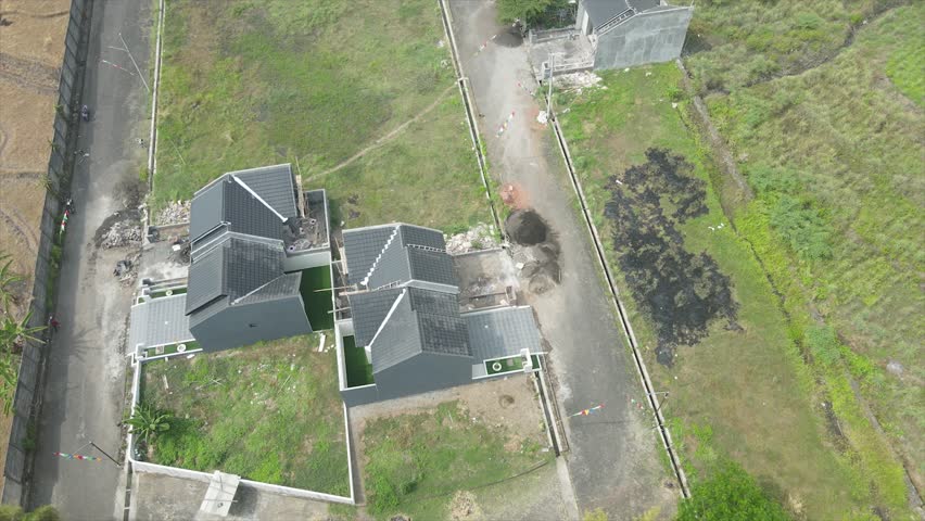 Top down aerial view of modern residential house construction in a rural suburban area.