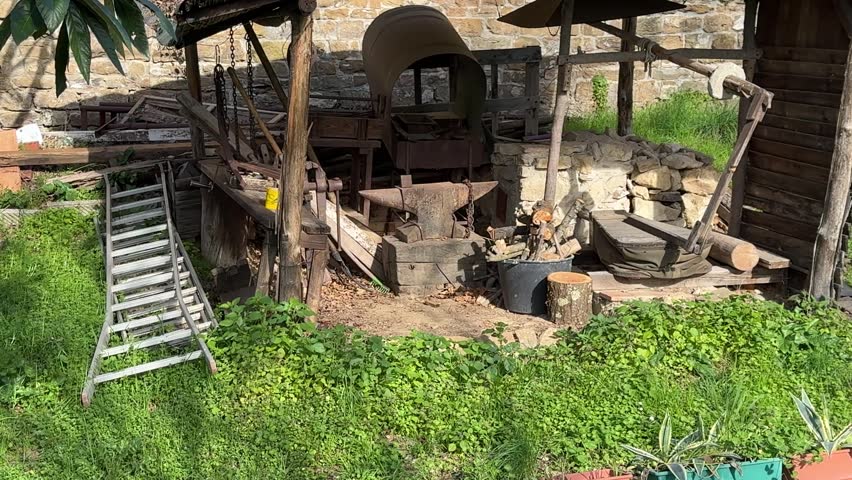 Traditional Blacksmith Workplace Nestled Against a Medieval Defensive Wall