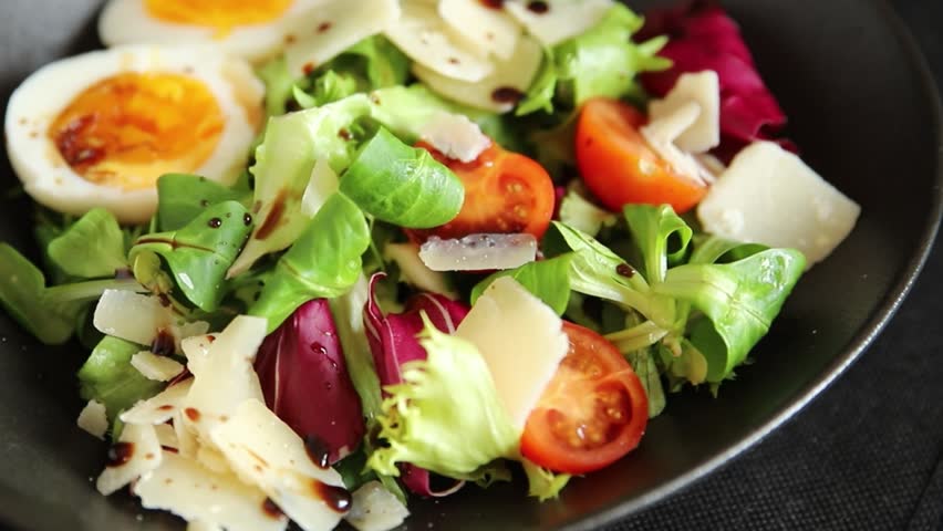 Egg salad parmesan, vegetables, green leaf lettuce, tasty snack fresh gourmet food background on the table, rustic food, top view, copy space keto and paleo diet