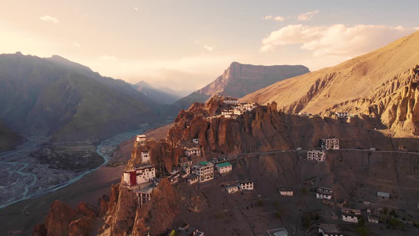 4K Aerial view of Dhankar monastery on cliff and river flowing in valley during sunset at Spiti Valley, Himachal Pradesh, India. Majestic mountain landscape. Travel India concept.