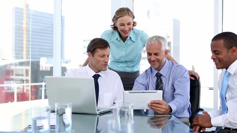 Group of business people using laptop and tablet computer during a meeting