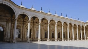 Historic mosque courtyard with arches and columns in Cairo, Egypt, captured in slow motion 4K during travel. - Powered by Shutterstock - Get 15% off with code: PIKWIZARD15