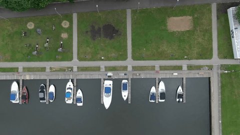 Vertical Aerial Shot Boats along River Dock