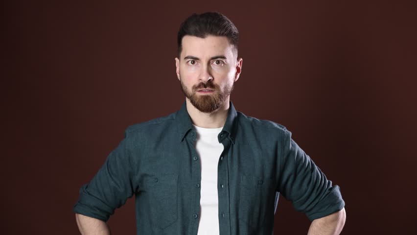 PEnsive man having idea and smiling on brown background