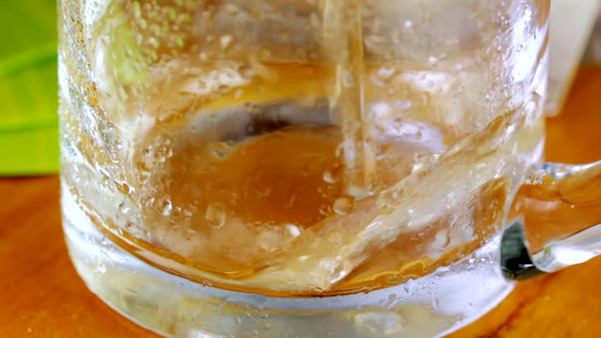Pouring beer into pint glass, shot in HD video