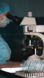 Laboratory technician working with microscope and sample slides in clinical lab, scientific analysis process and medical research environment. - Powered by Shutterstock - Get 15% off with code: PIKWIZARD15