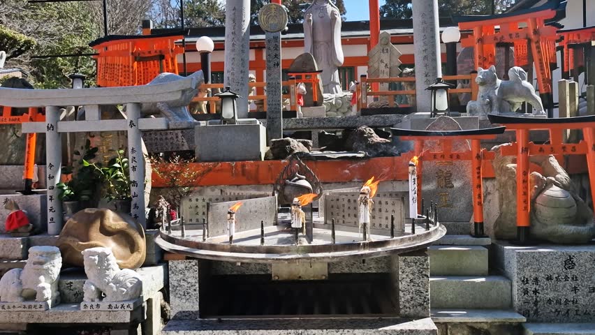 Fushimi Inari Taisha Shinto Shrine Complex in Kyoto, Japan, Orange Gates and Fire at Worship Place
