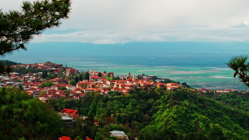 Aerial drone view of Sighnaghi, Georgia, showcasing the hilltop town, surrounding landscape, and charming architecture from above in clear daylight.