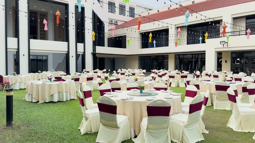 Outdoor event space, banquet tables, chairs, party setup, lawn decoration.