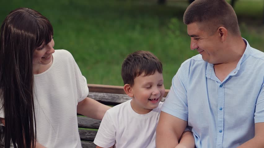 happy family, child parent park, child boy son laughing hugging parent sitting bench park, mother father child having fun hugging outdoors, woman laughing, man laughing, child boy laughing, man woman