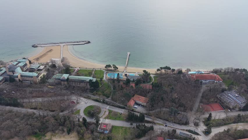 Aerial view of coastal city with beach, sea and urban landscape along shoreline